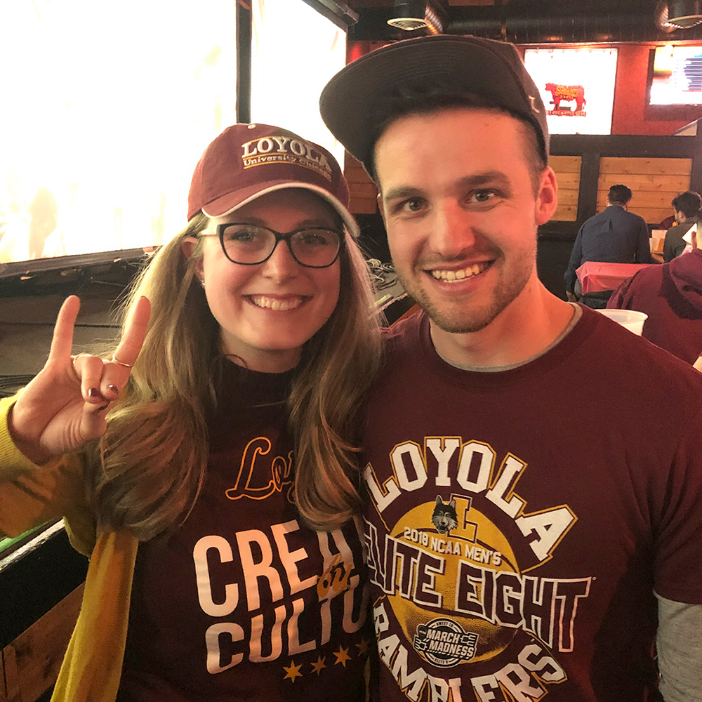 Photo of alumni Dan and Anna Ziemniak wearing Loyola Athletics tee shirts and caps