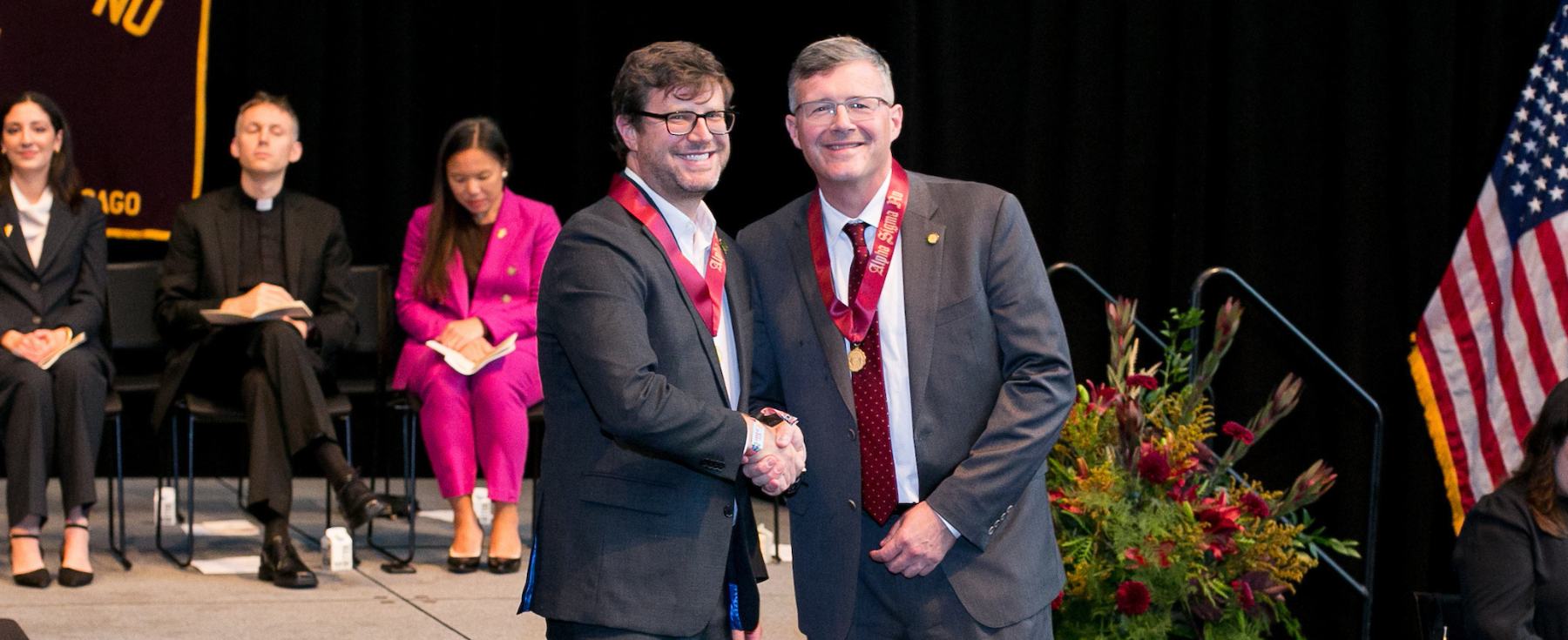 School of Education student Ryan Johnson shakes hands with Dr. Woods.