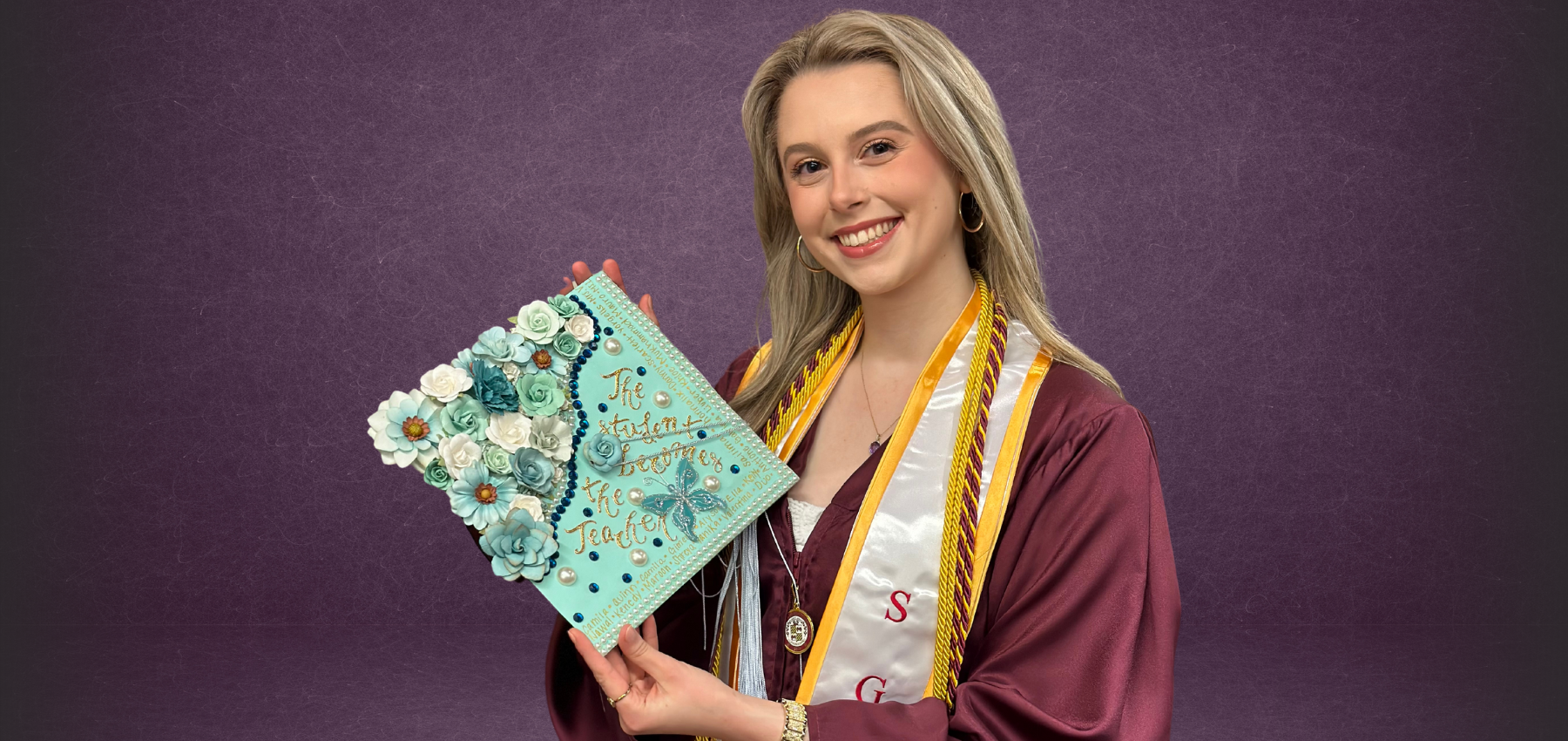 Loyola School of Education graduate Alexandra Brist holds commencement cap in hand