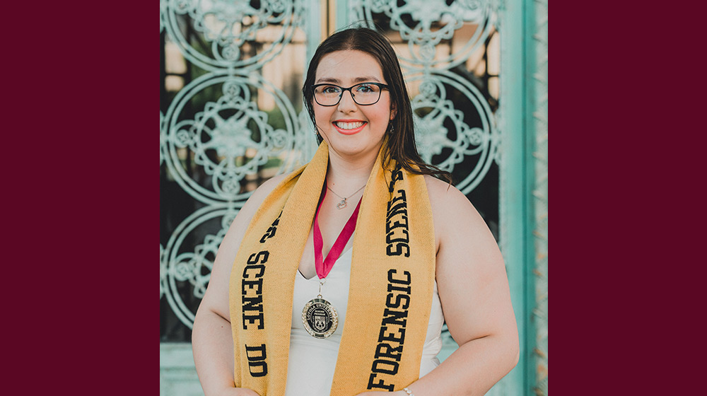 A person wearing a yellow scarf and glasses