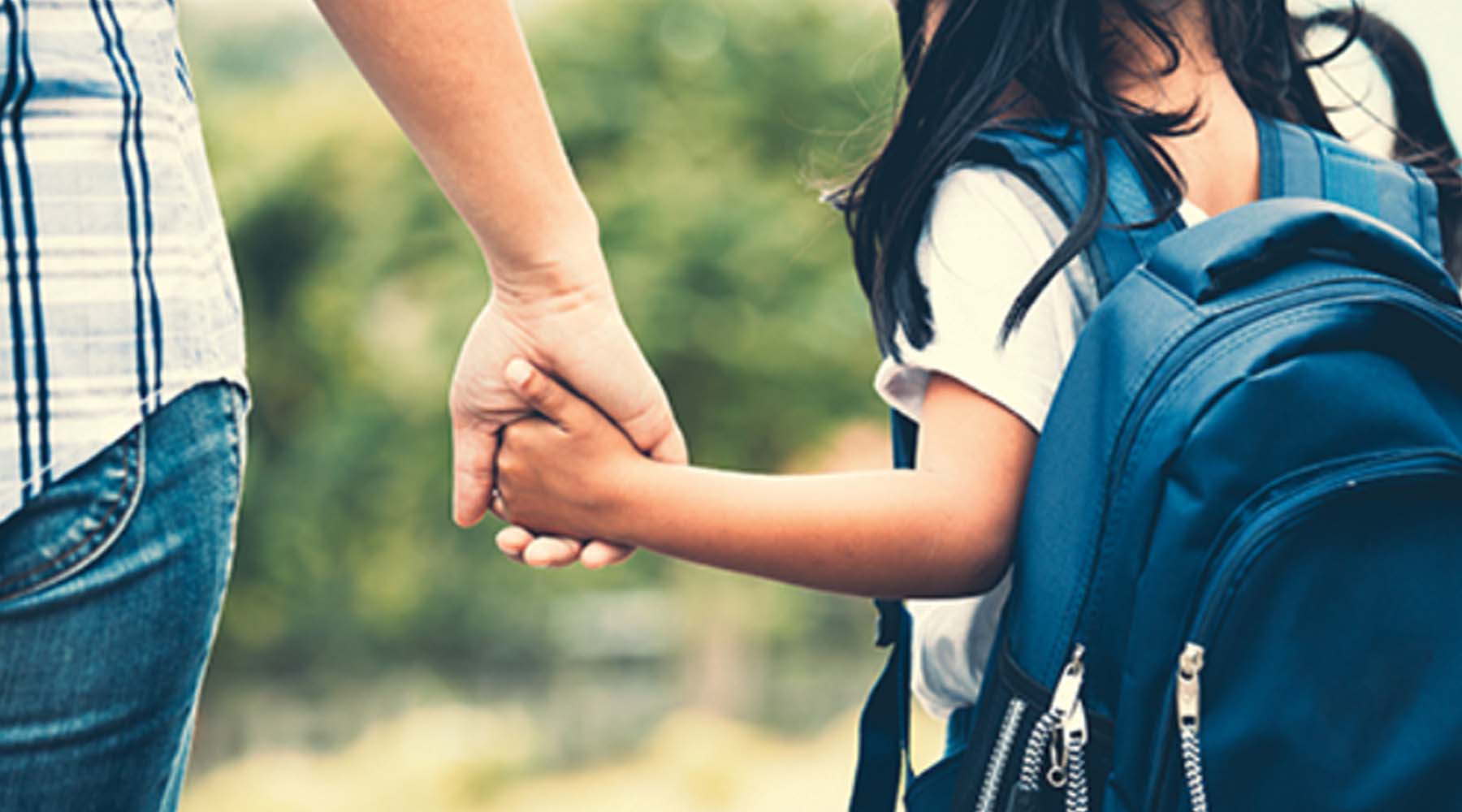 child holding an adult's hand