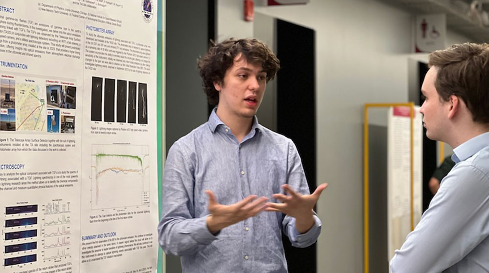 A physics student presenting at the symposium.