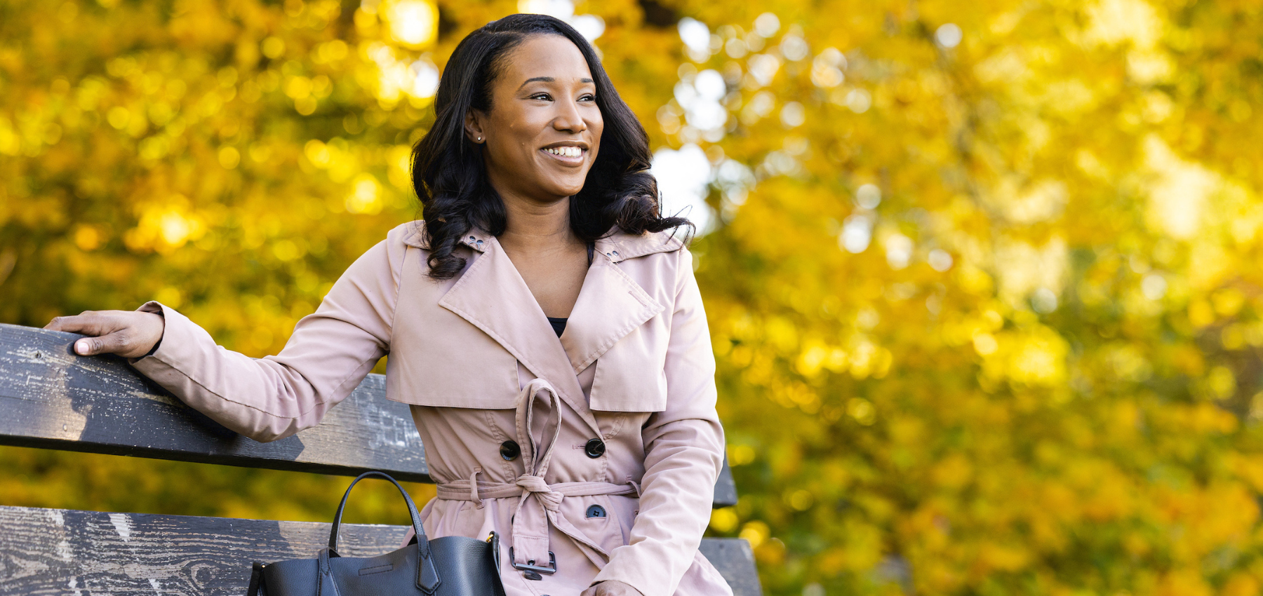 Loyola SCPS graduate, Krystal Westmoreland, sitting on a bench