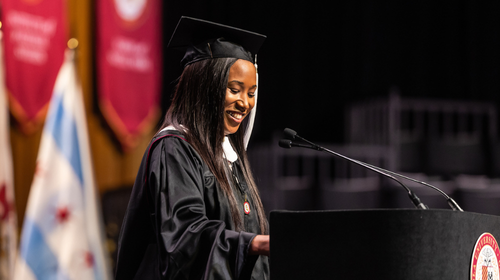 SCPS Graduate and Commencement speaker, Krystal Westmoreland standing at podium 