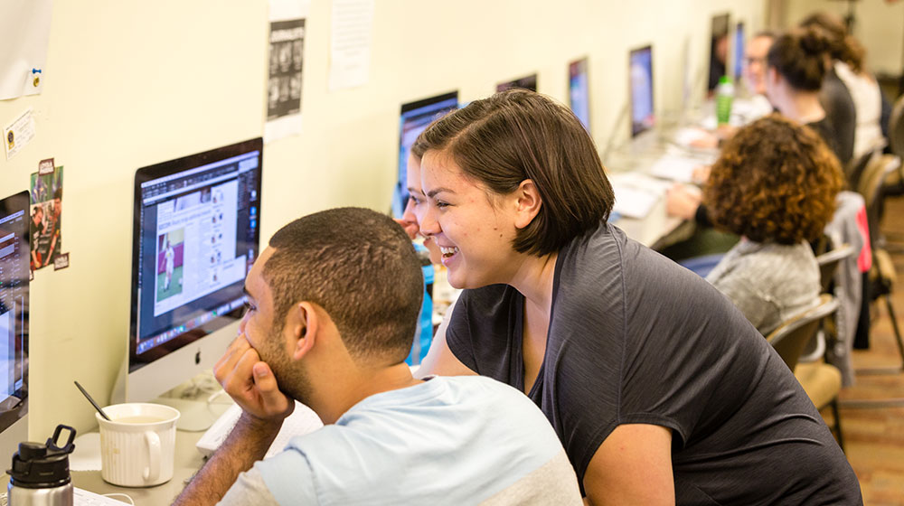 Marissa Boulanger (right), editor-in-chief of the Phoenix, helps direct production for an issue of the student-run newspaper. “I hope people understand that we won this award and we are very proud of it,” she said. “But we are even more proud that we are at a university that allows us to do that.” (Photo: Mark Patton)