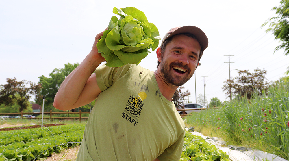 Tony Minnick holding a head of lettuce